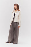 VIDA MOULIN cream twill cotton jacket with a relaxed fit, button front, and two chest pockets. Model wears it with grey wide-leg pants.