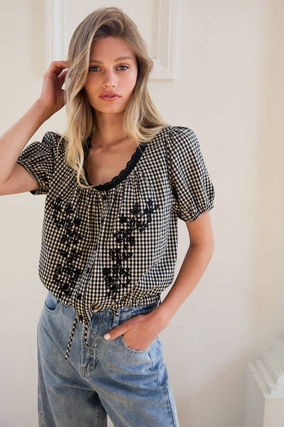 VIDA MOULIN black and white gingham blouse with floral embroidery, puff sleeves, and scoop neckline. Cotton blend.
