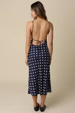VIDA MOULIN navy blue midi dress with white polka dots, open back, and tie detail. Lightweight linen blend.