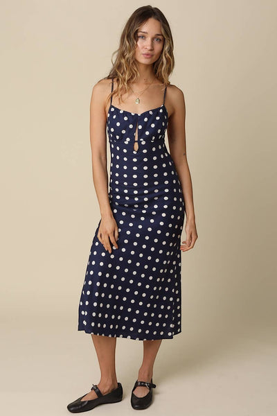 VIDA MOULIN navy blue midi dress with white polka dots, sweetheart neckline, cut-out detail and adjustable straps.