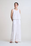 VIDA MOULIN white sleeveless 100% cotton eyelet swing top with round neck and back tie detail.
