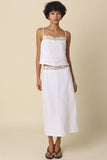 VIDA MOULIN white linen cami top with lace trim and adjustable spaghetti straps, paired with a matching skirt.