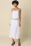 VIDA MOULIN white linen cami top with lace trim and adjustable spaghetti straps, paired with a matching skirt.